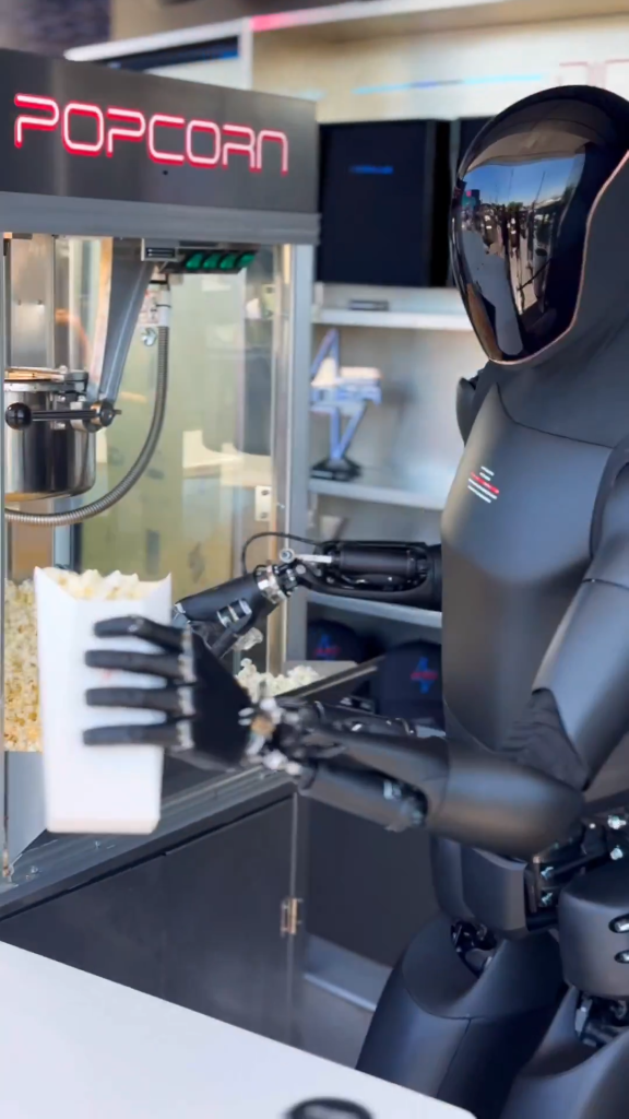 All black Tesla Optimus humanoid robot serves popcorn at Tesla's diner